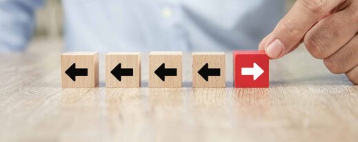 businessman-hand-choose-cube-wooden-toy-blog-with-arrow-heads-icons-pointing-opposite-directions